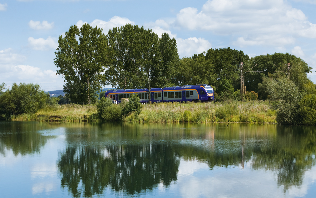 train running next to lake
