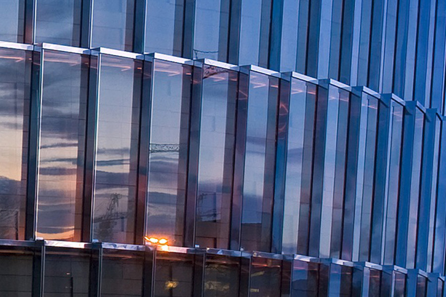 Closeup of series of glass windows catching the light
