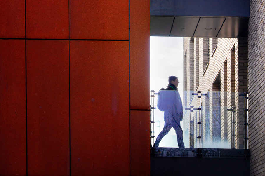 Close up of women walking past window in building