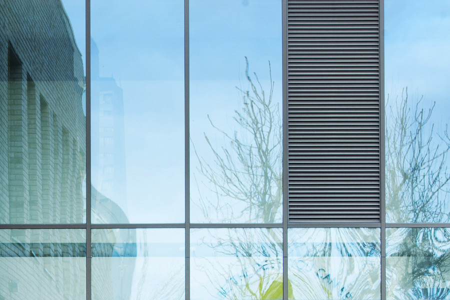 INPP close up image of glass window with tree and side building behind